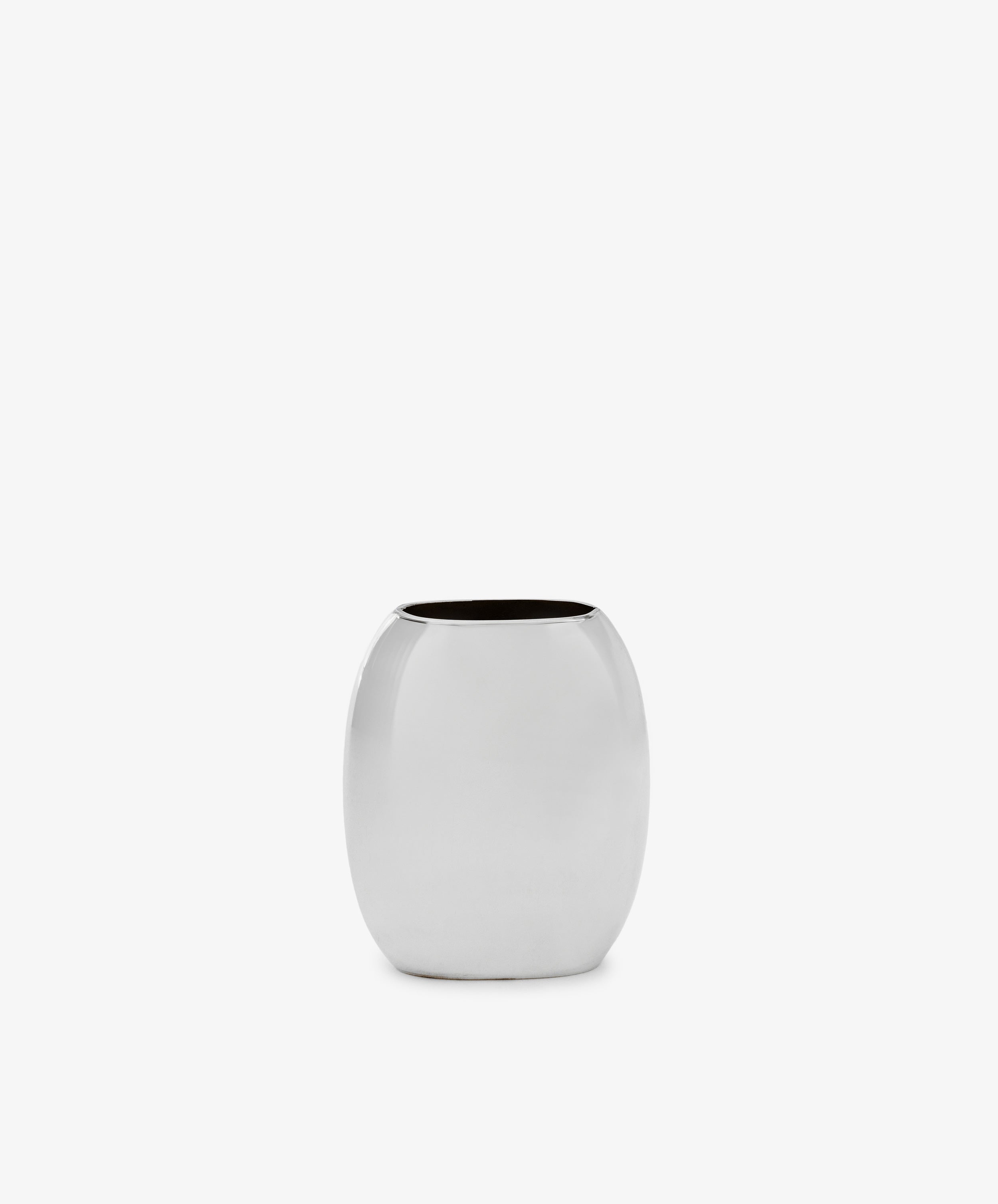 The Vera Oval Budvase is a small, oval-shaped bud vase with a polished pewter finish and wide opening, inspired by Josef Hoffmann, shown against a plain white background.