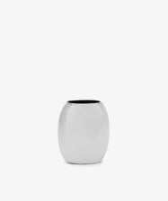 The Vera Oval Budvase is a small, oval-shaped bud vase with a polished pewter finish and wide opening, inspired by Josef Hoffmann, shown against a plain white background.