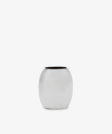 The Vera Oval Budvase is a small, oval-shaped bud vase with a polished pewter finish and wide opening, inspired by Josef Hoffmann, shown against a plain white background.
