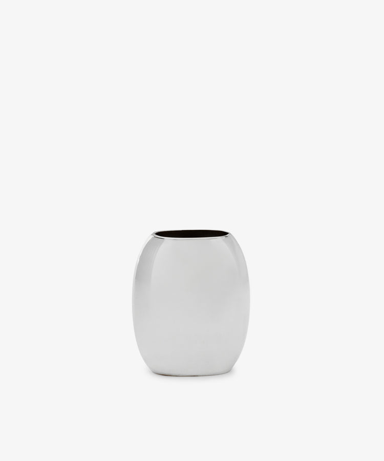 The Vera Oval Budvase is a small, oval-shaped bud vase with a polished pewter finish and wide opening, inspired by Josef Hoffmann, shown against a plain white background.