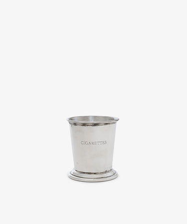 The Cleo Cigarette Cup is a silver cylindrical container engraved with 