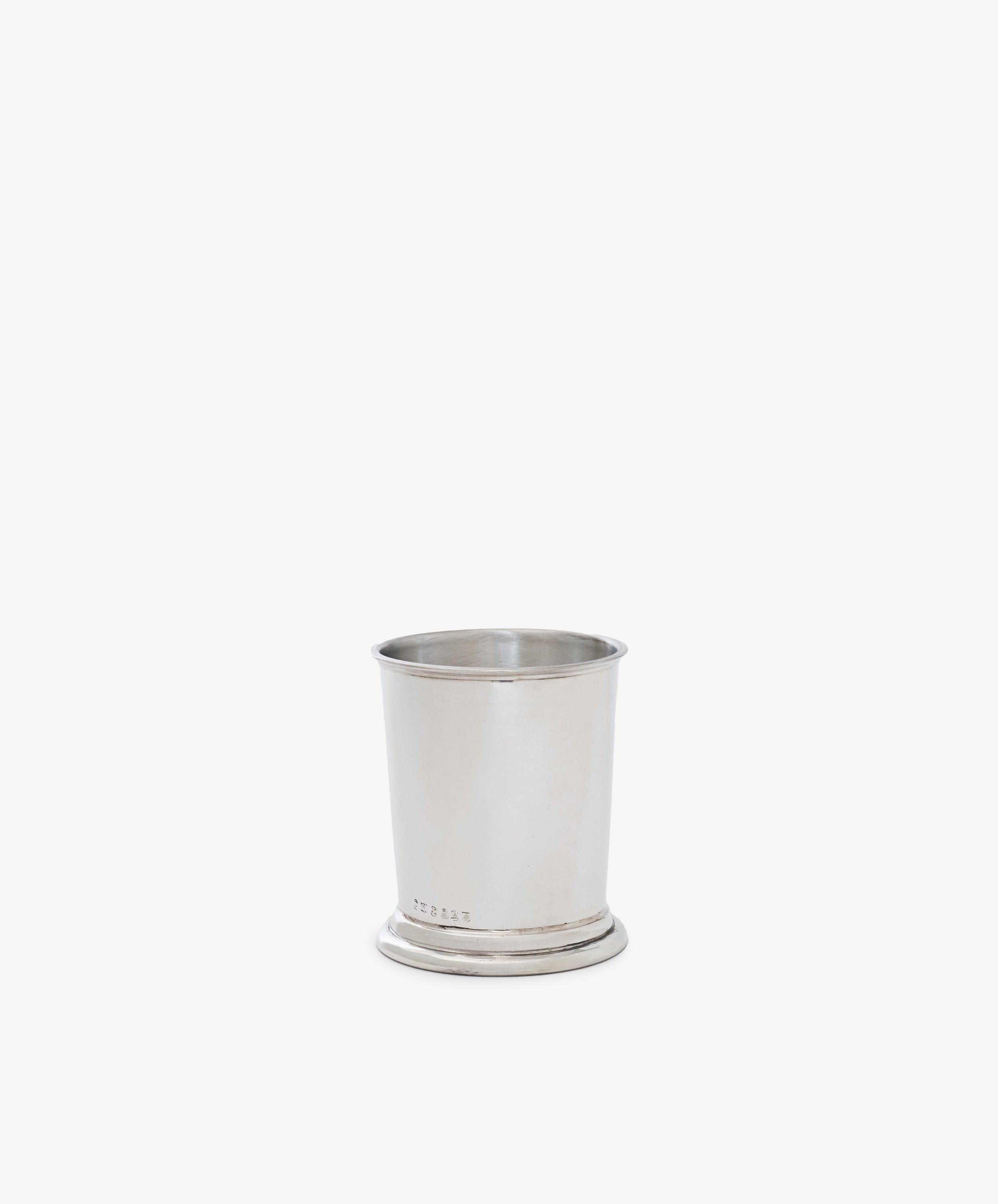 The Clara Julep Cup features plain silver with a slightly flared rim and small circular base, evoking classic home decor. Perfect as a pewter julep cup, it is photographed against a white background.