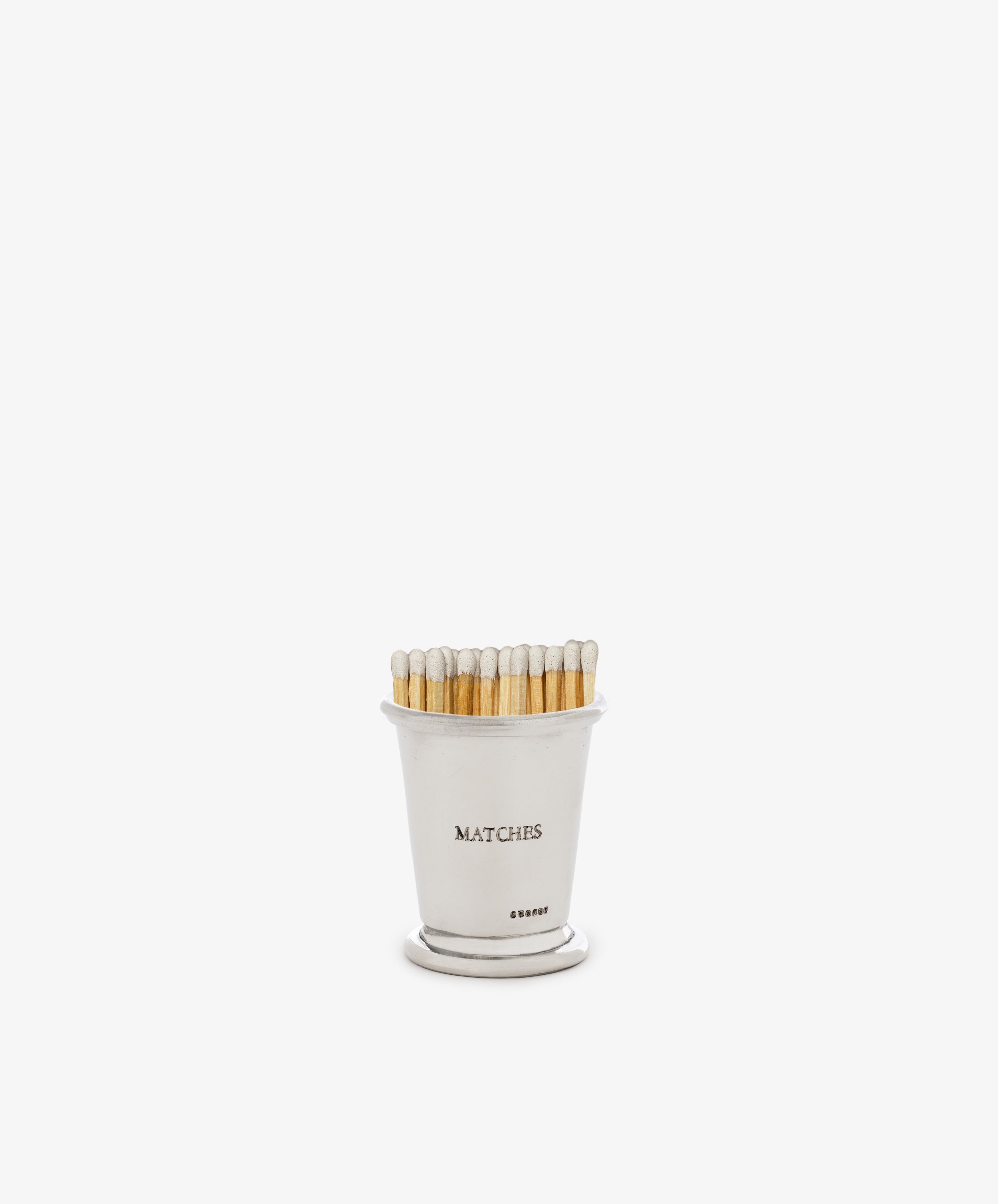 The Jude Match Cup & Striker is a small silver holder labeled MATCHES, filled with white-tipped wooden matches, displayed on a plain white background.