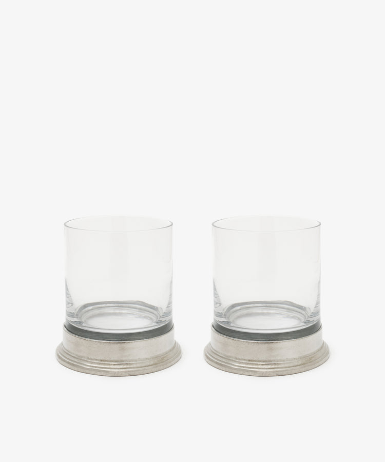 A set of two Leo Double Old Fashioned Glasses, each with a wide pewter base and clear glass, are displayed side by side against a plain white background.