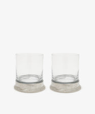 The Leo Double Old Fashioned Glasses, Set of 2, feature clear glasses with wide pewter bases placed side by side on a white background.