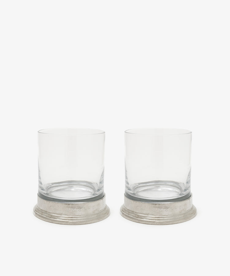 The Leo Double Old Fashioned Glasses, Set of 2, feature clear glasses with wide pewter bases placed side by side on a white background.