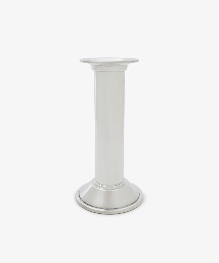 The Dario Candle Holder is a plain silver pewter piece featuring a cylindrical stem and a round base, shown against a white background.