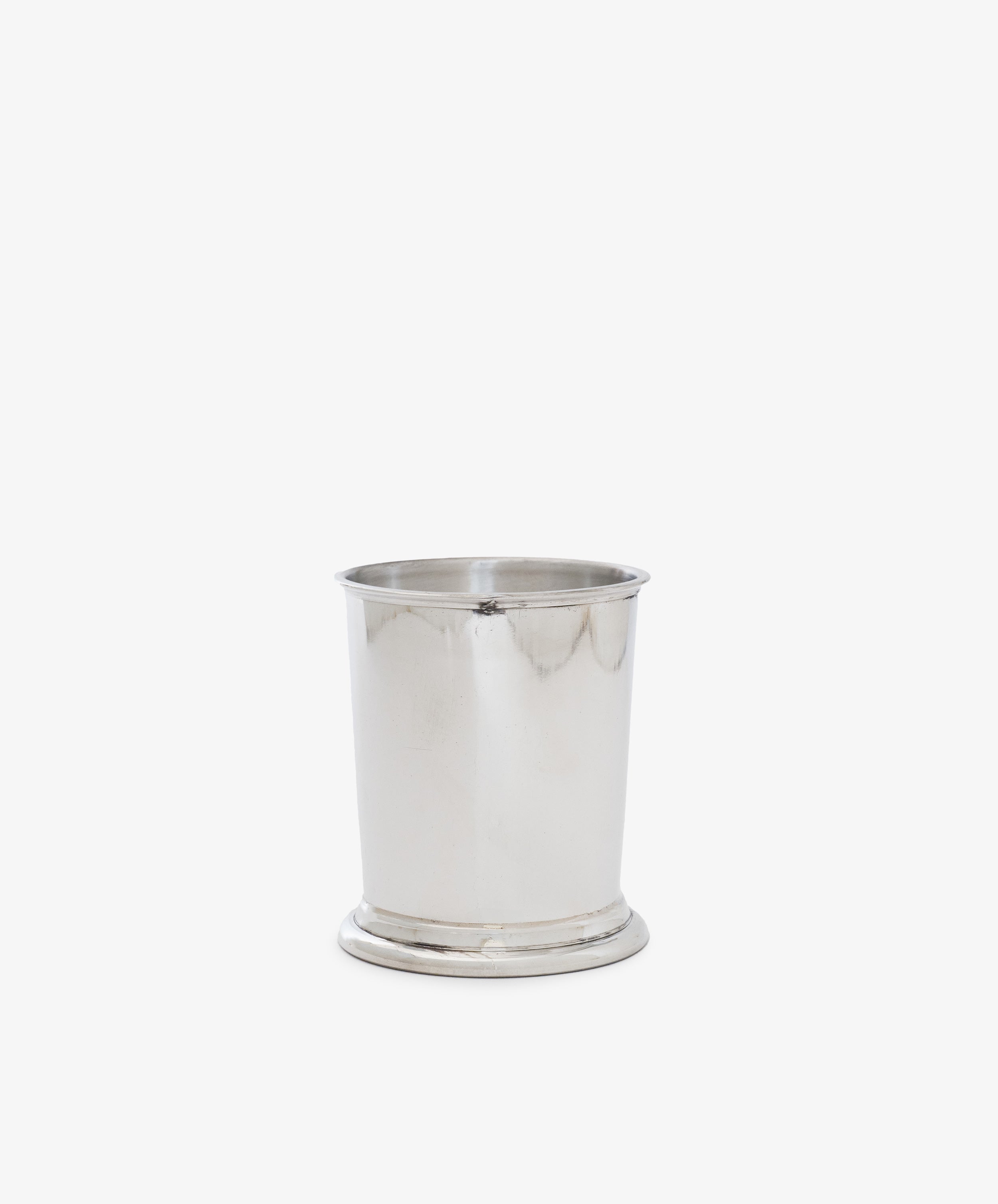 The Serena Pencil Cup, with its sleek pewter finish, rests on a white background, creating an elegant desk accessory.