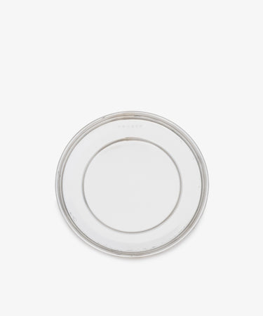 The Greta Small Bread Plate—a clear, round glass plate with a simple design, shown from above on a white background—is a timeless essential for any setting.