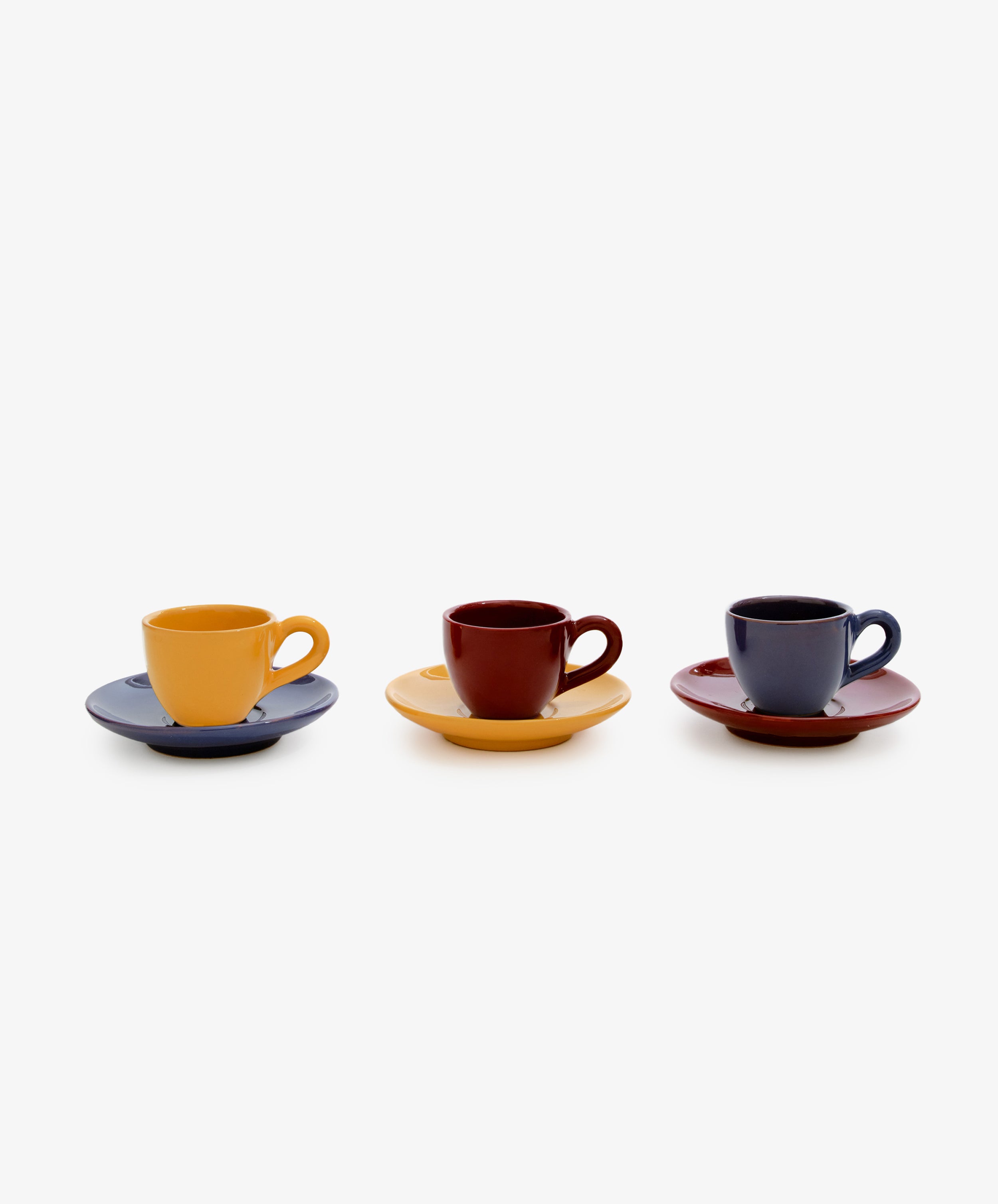 Gio Espresso Set. Three glazed ceramic espresso cups with mismatched saucers, in mustard, burgundy and dark blue.