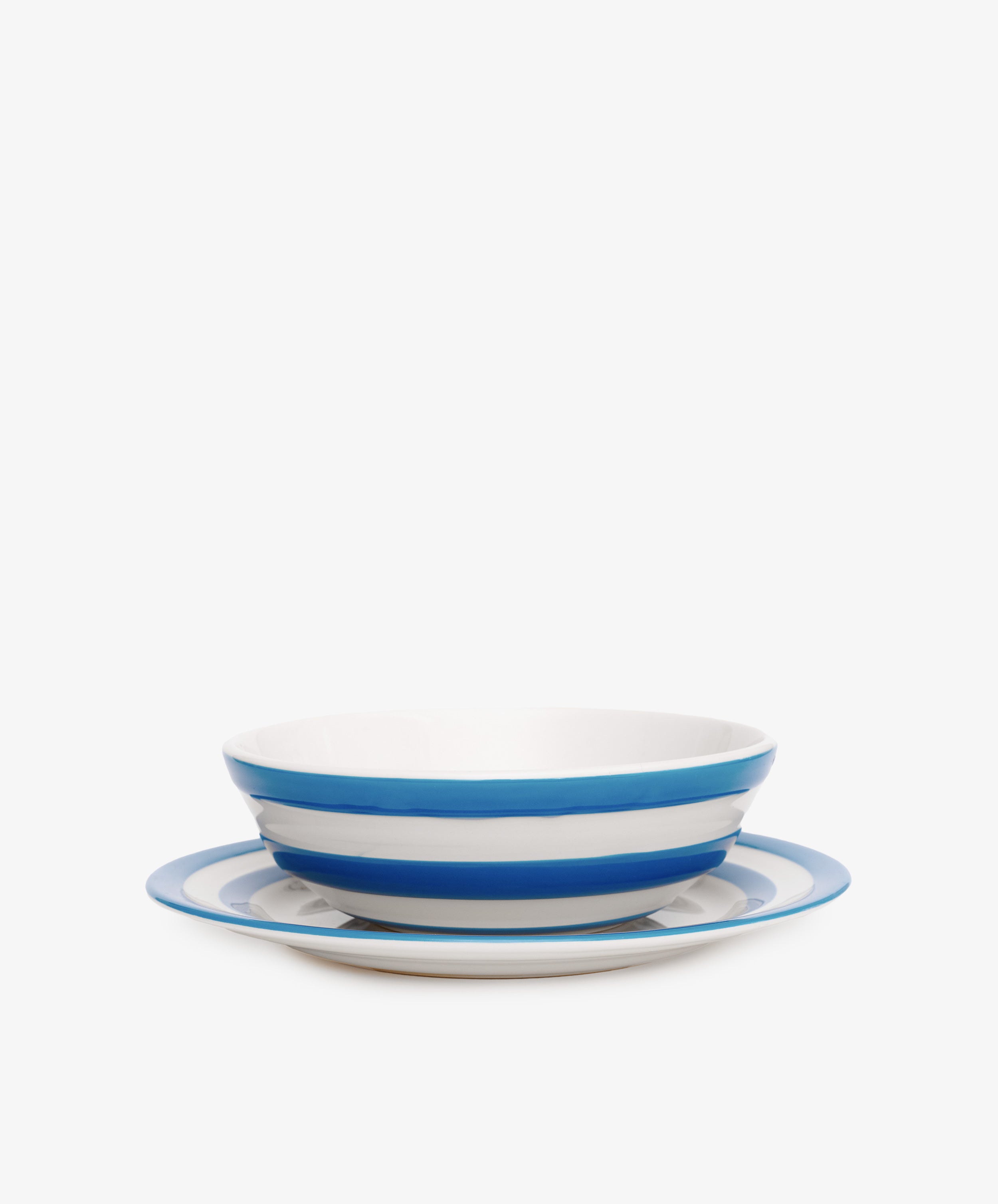 The Betty Bundle includes a white ceramic cereal bowl and matching breakfast plate, both featuring the iconic Cornish blue and white stripes, displayed against a plain white background.