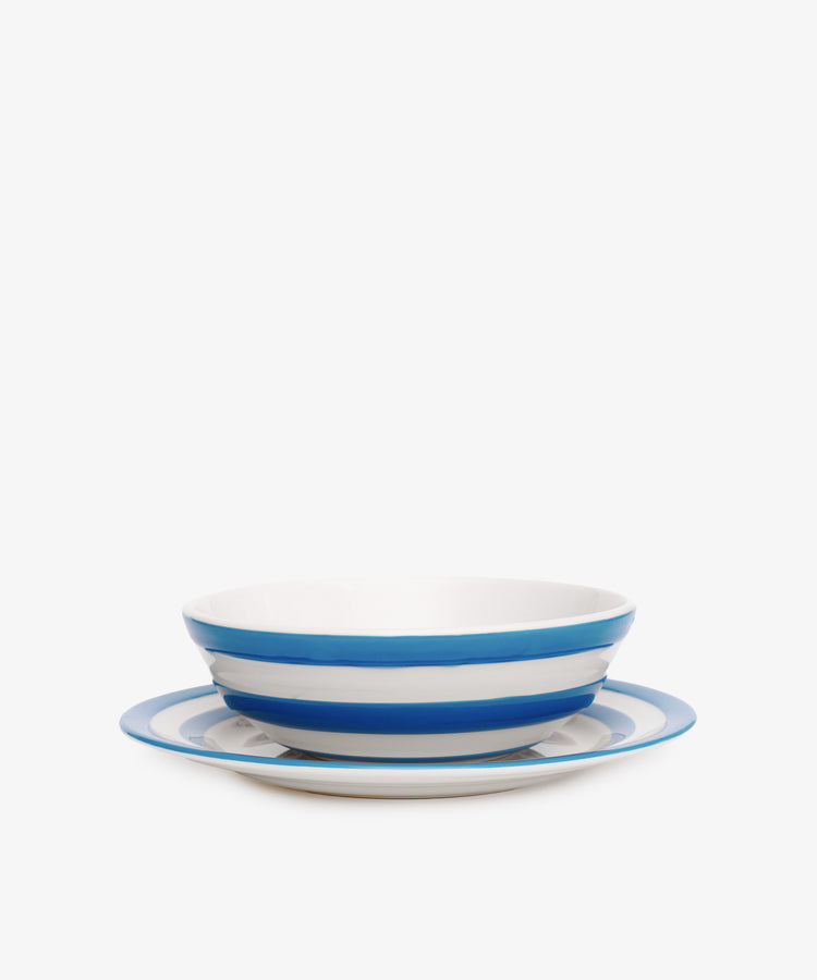 The Betty Bundle includes a white ceramic cereal bowl and matching breakfast plate, both featuring the iconic Cornish blue and white stripes, displayed against a plain white background.