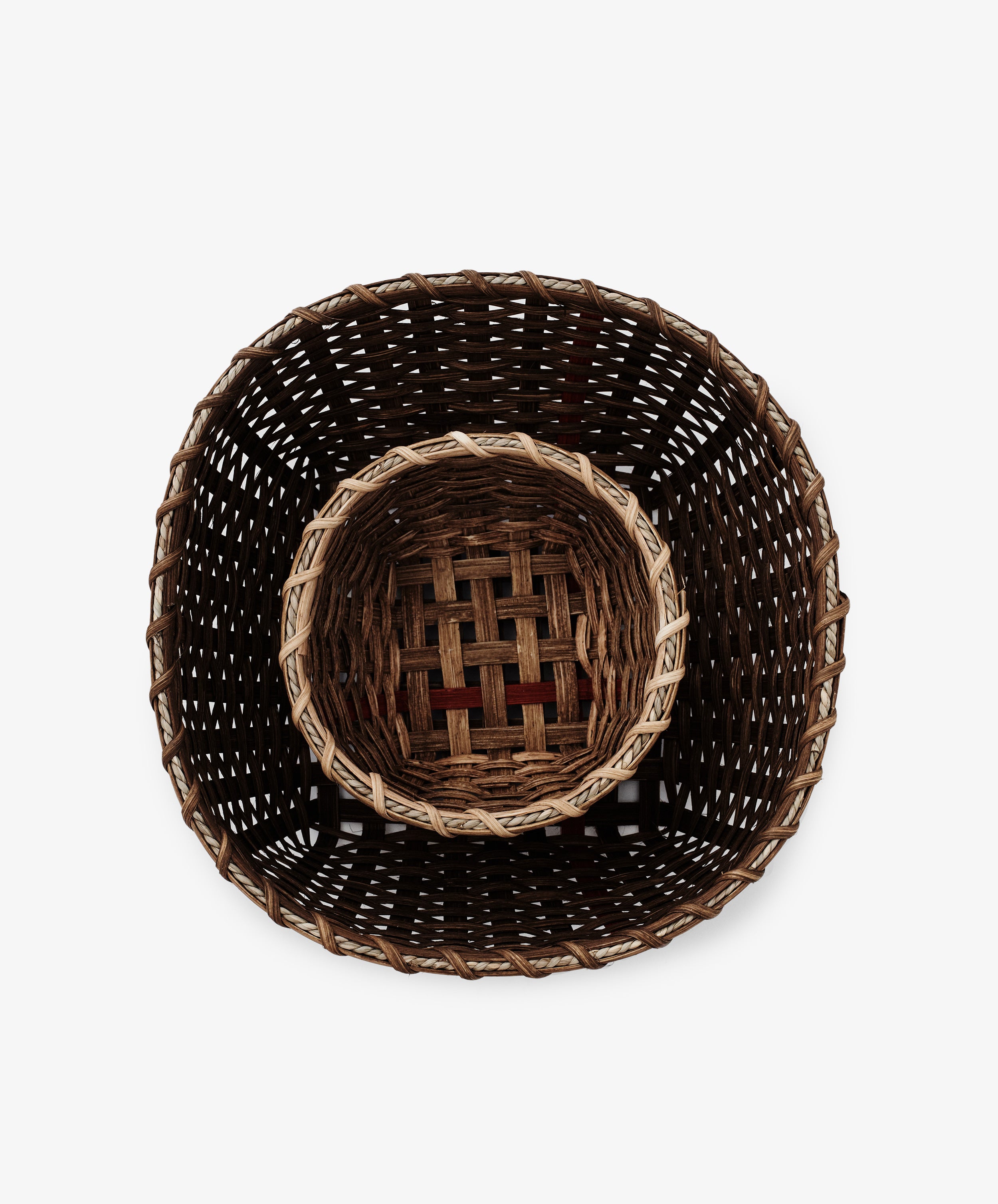 Top view of a Medium Love Basket made from woven rattan, with a smaller basket nested inside the larger one, set against a plain white background.