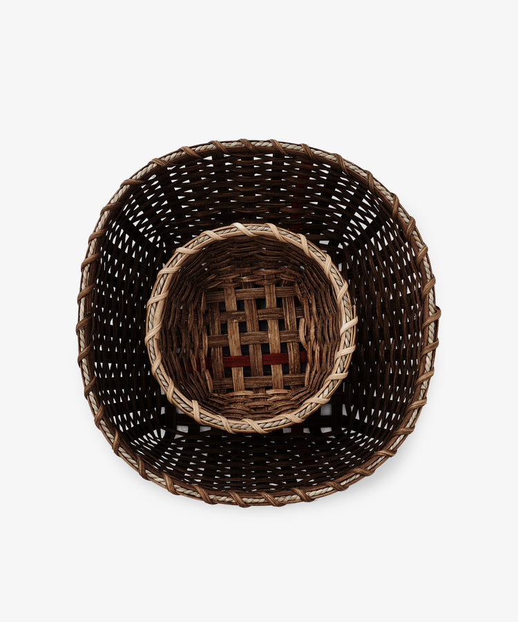 The Little Love Basket, a small handwoven piece, nestles neatly inside a larger woven basket. Both are displayed from above on a plain white background.