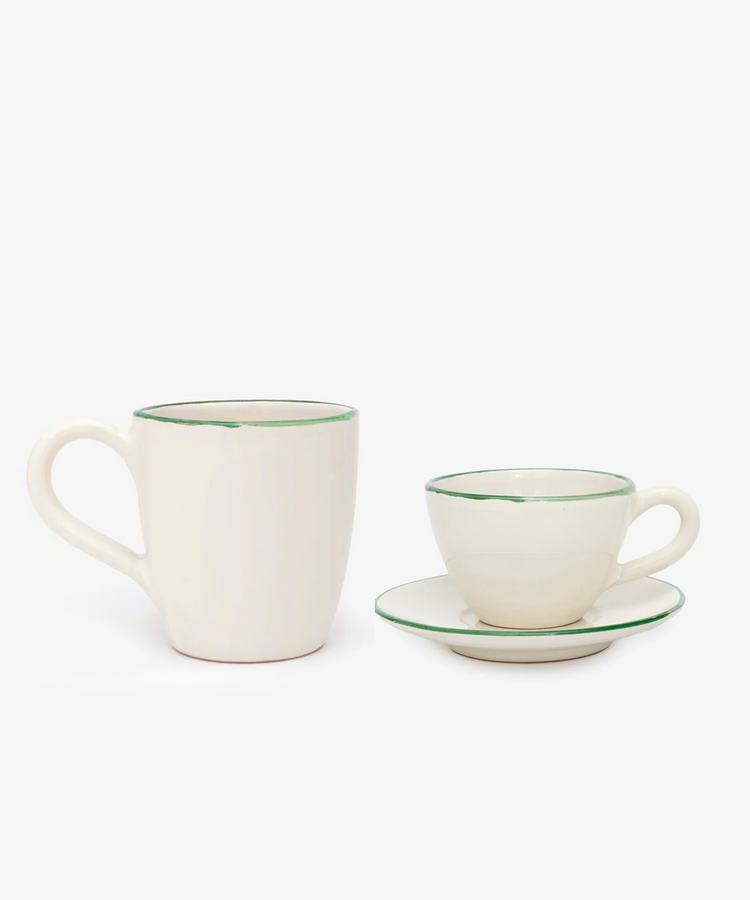 The Guido Coffee Bundle features a white ceramic mug and a matching coffee cup with saucer, each accented by a green rim, creating an elegant breakfast set against a simple background.