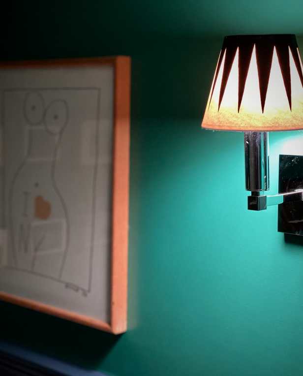 Wall sconce with a black and white patterned lampshade