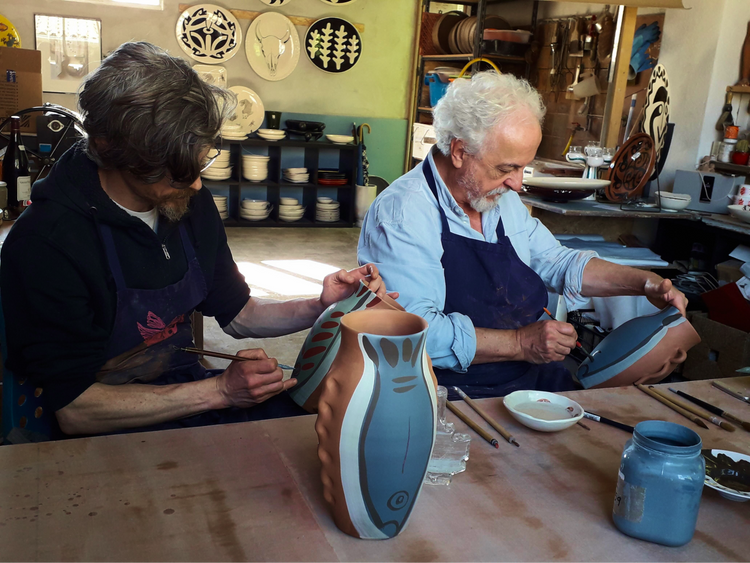 two men in studio painting ceramics