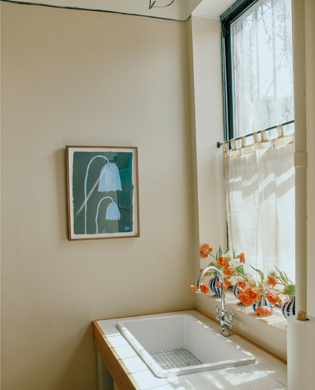 floral painting on wall next to sink