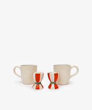 The Breakfast for Two Bundle features two cream coffee mugs with handles and two red and white ceramic egg cups, creating a simple yet charming Valentine’s Day breakfast scene on a plain white background.