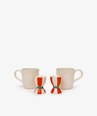 The Breakfast for Two Bundle features two cream coffee mugs with handles and two red and white ceramic egg cups, creating a simple yet charming Valentine’s Day breakfast scene on a plain white background.