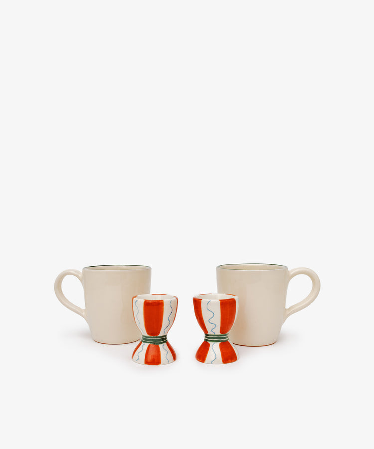 The Breakfast for Two Bundle features two cream coffee mugs with handles and two red and white ceramic egg cups, creating a simple yet charming Valentine’s Day breakfast scene on a plain white background.