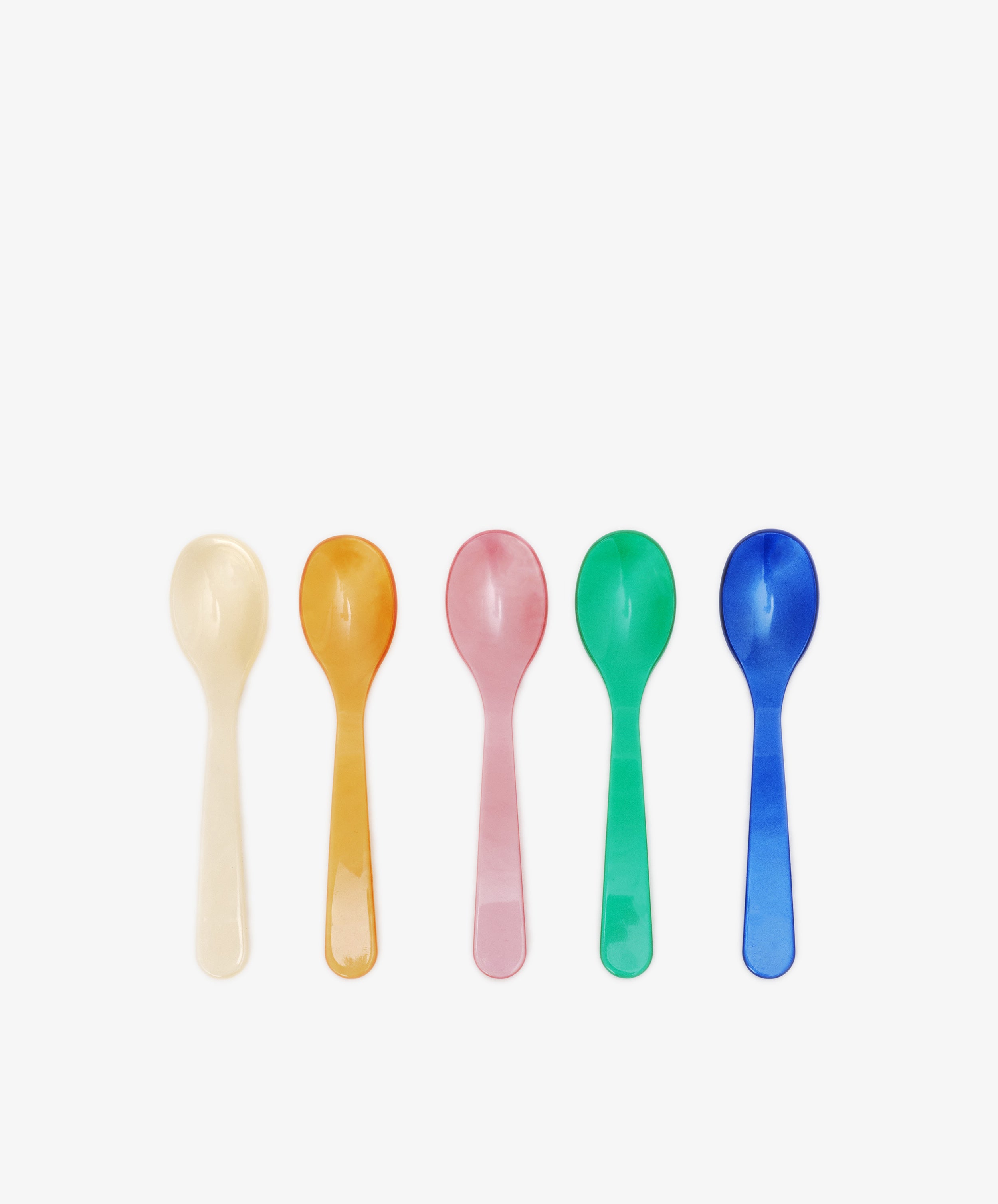 The Spooning Bundle includes five colorful plastic dessert spoons—white, orange, pink, green, and blue—arranged in a row. Ideal for brightening your table or as a fun addition to a Valentine’s Day bundle.