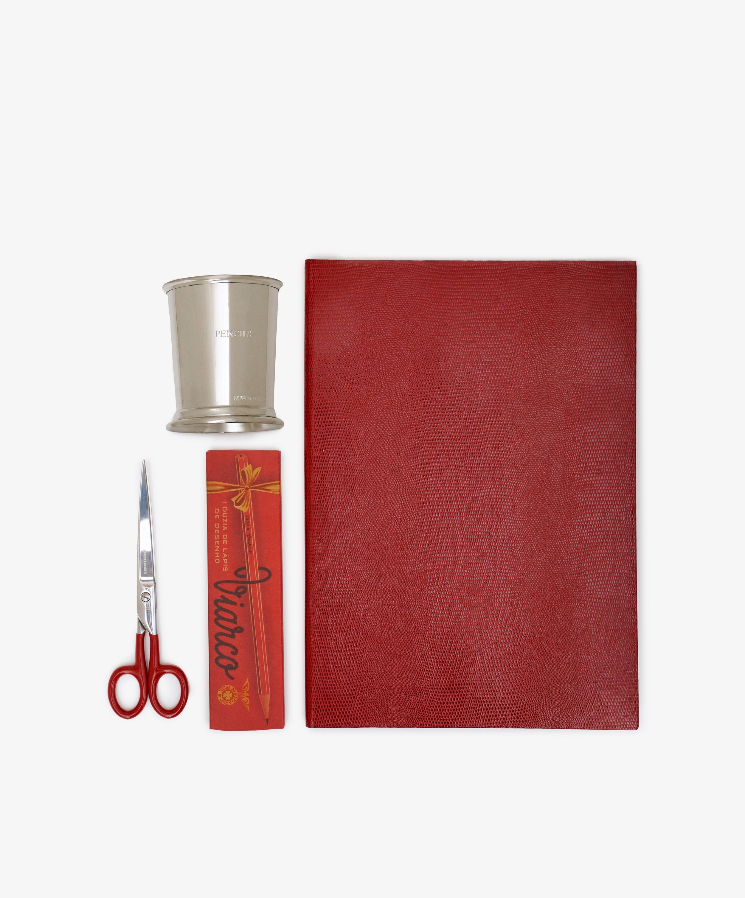 The Red Desk Bundle features red-handled scissors, a silver cup, a red incense box, and a red leather journal arranged neatly on a white background.