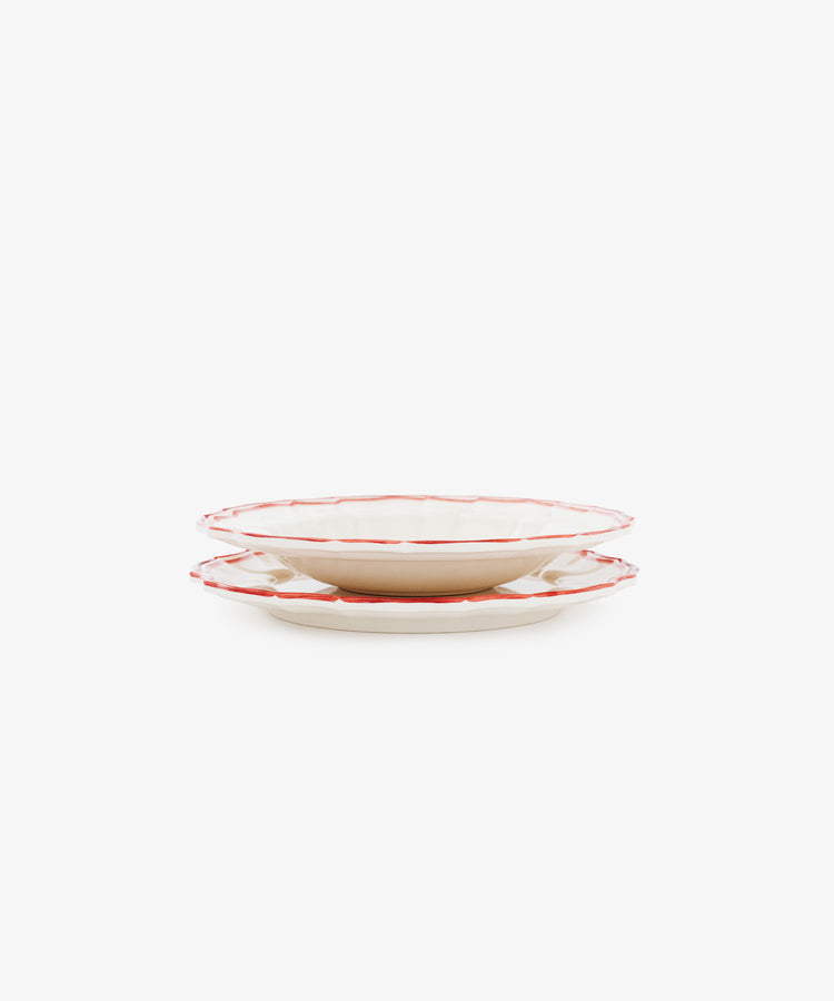 A set of four Eva Melamine Small Plates, BPA-free with a white design and red trim, are displayed stacked against a plain white background.