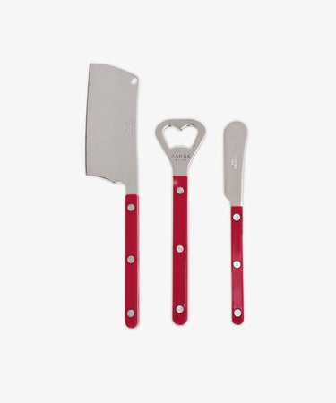 The Good Bits Bundle includes three metal kitchen tools with red handles—a cheese cleaver, bottle opener, and butter knife—arranged vertically on a white background, making it an ideal Valentine’s Day gift.
