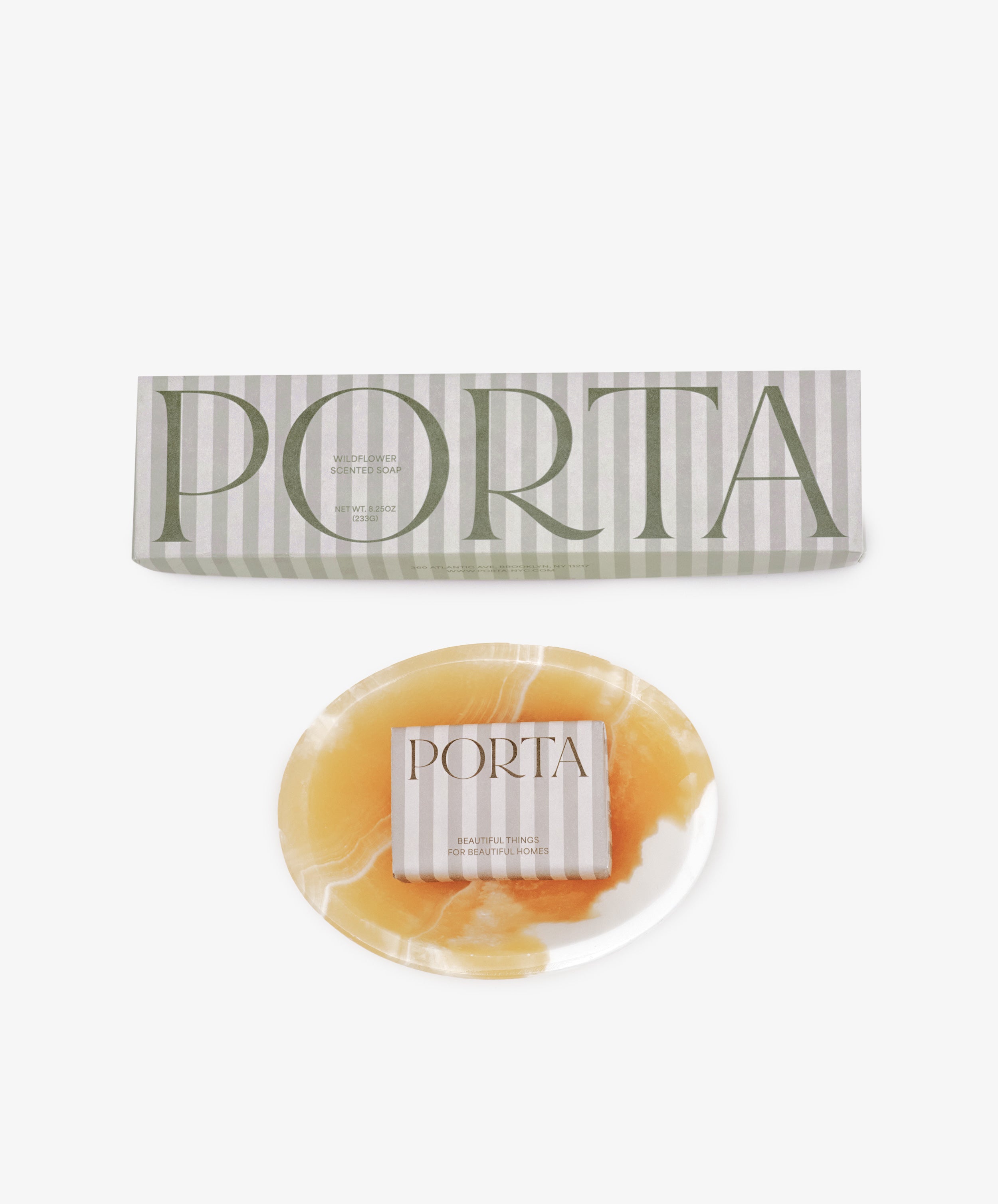A round, marbled yellow and white soap bar from the Squeaky Clean Bundle rests beneath a rectangular branded box—an ideal gift for daily rituals, beautifully displayed against a white background.