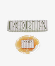A round, marbled yellow and white soap bar from the Squeaky Clean Bundle rests beneath a rectangular branded box—an ideal gift for daily rituals, beautifully displayed against a white background.