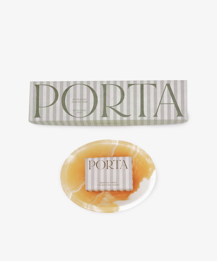 A round, marbled yellow and white soap bar from the Squeaky Clean Bundle rests beneath a rectangular branded box—an ideal gift for daily rituals, beautifully displayed against a white background.