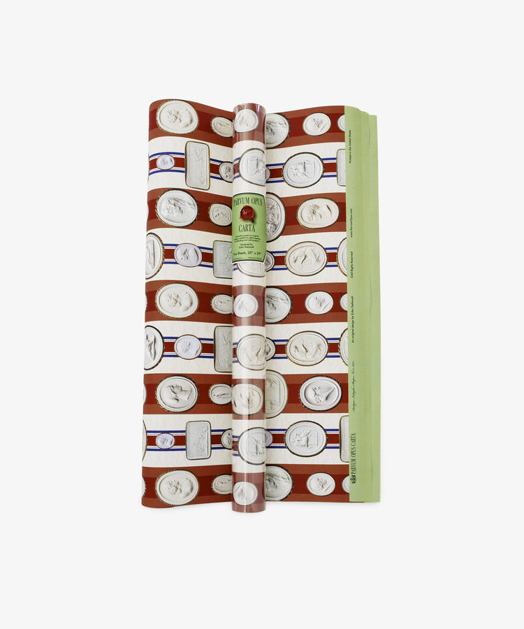 A roll of Intaglio Stripe Gift Wrap in red with coin illustrations and a central green label—ideal as neoclassical gift wrap for collectors, shown on a white background.