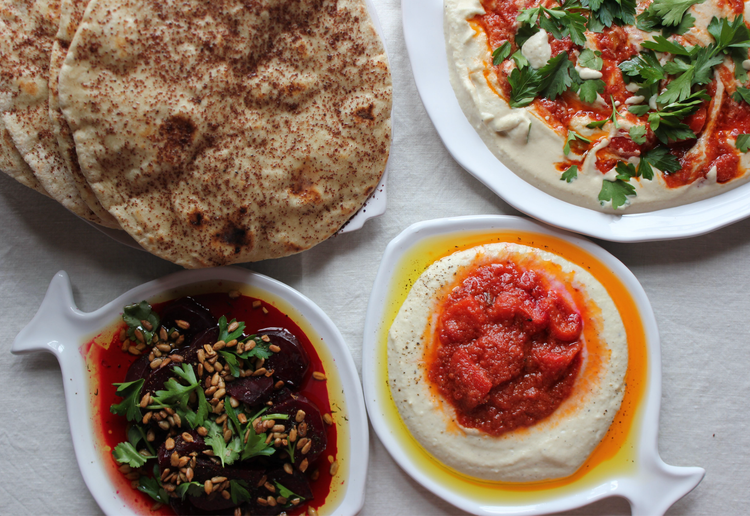 Flatbread with hummus and mezze dishes