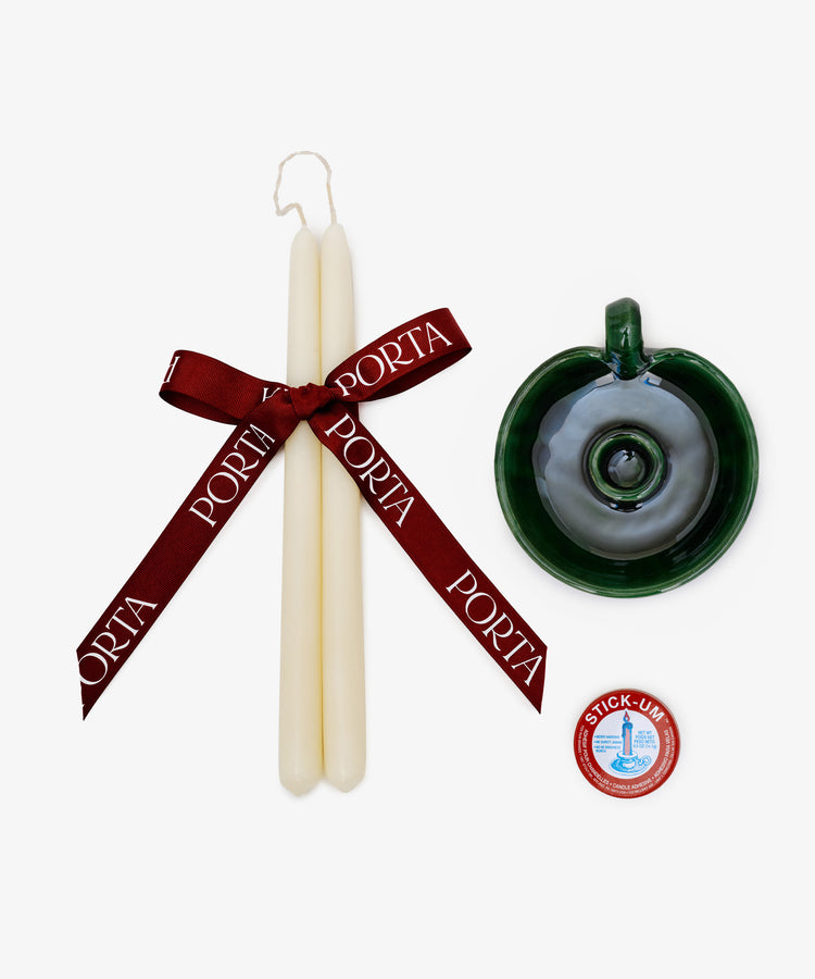 The Wax & Wick Bundle features two white tapered candles with a maroon PORTA ribbon, a green ceramic holder, and a small tin of candle adhesive displayed on a white background.
