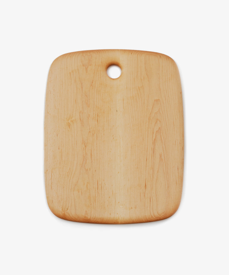 Birds Eye Maple Chopping Board. Rounded edge medium rectangular wooden cutting board with circular hole at top centre.