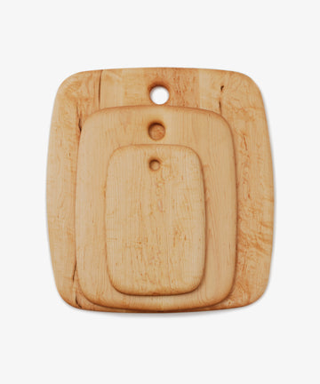 Nested maple chopping boards in three different sizes, overhead view.