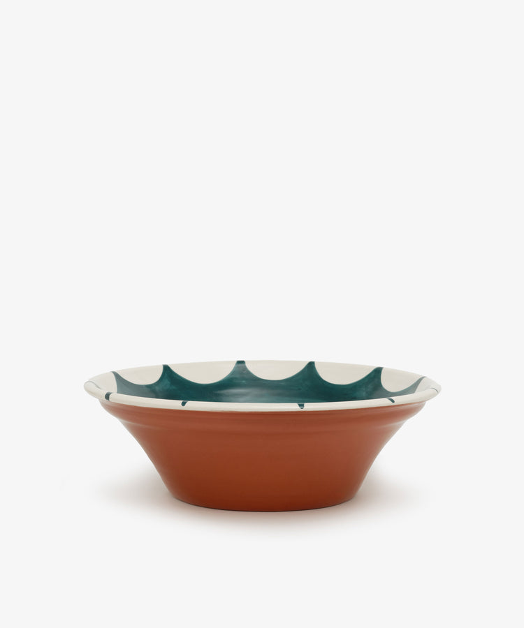 Stella Serving Bowl.  Glazed terracotta bowl with white rim and dark green design, side view.