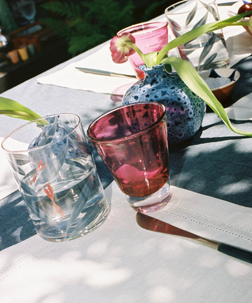 Outdoor tablescape with Pom Bud Vase holding tulips.