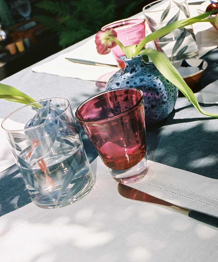 Outdoor tablescape with Pom Bud Vase holding tulips.