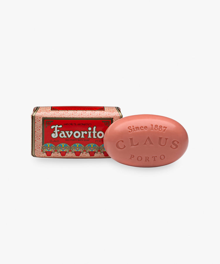 Claus Porto Soap, Favorito. Oval bar of pink soap with pink and red art deco paper packaging.