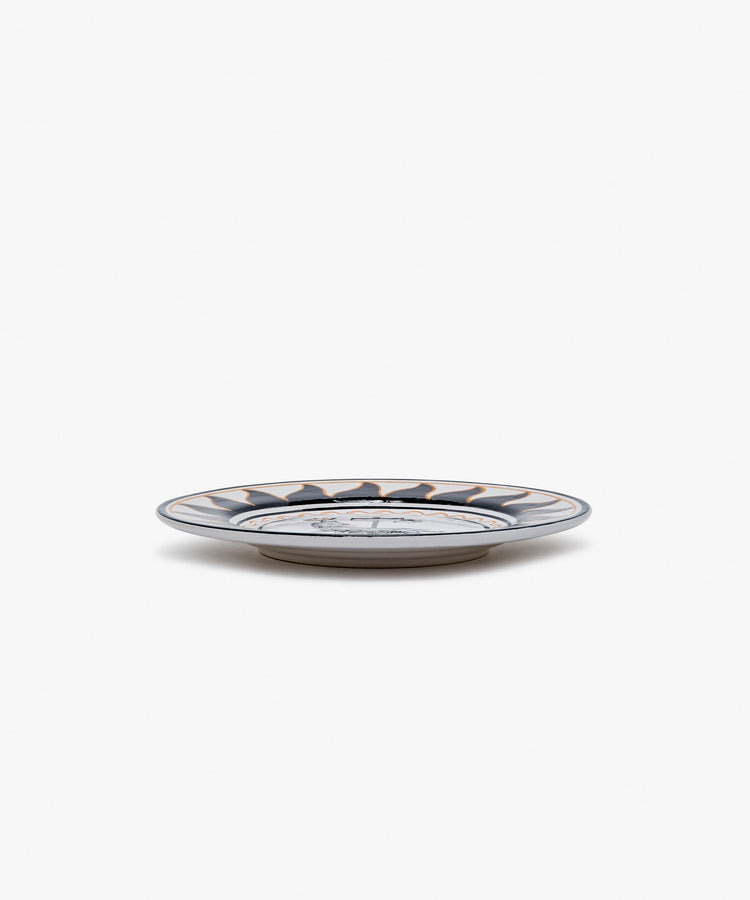 Palio Small Plate in white glazed ceramic with black and orange designs, side view.