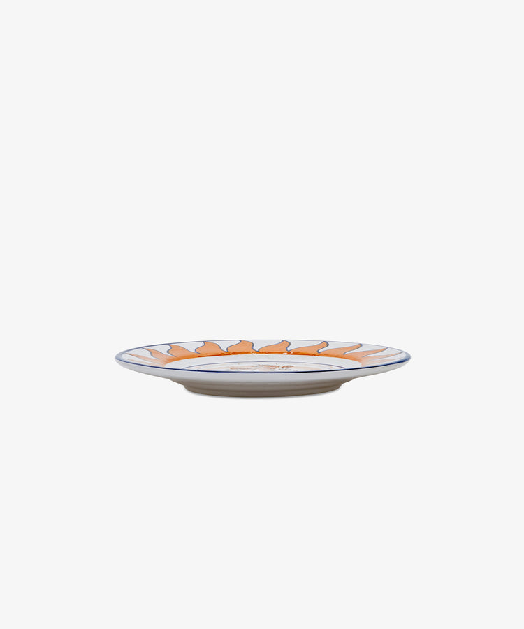 Palio Small Plate in white glazed ceramic with orange and blue designs, side view.