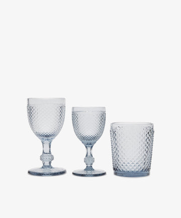 A set of six Celeste white wine glasses with diamond-cut textured surfaces, shown against a plain white background.