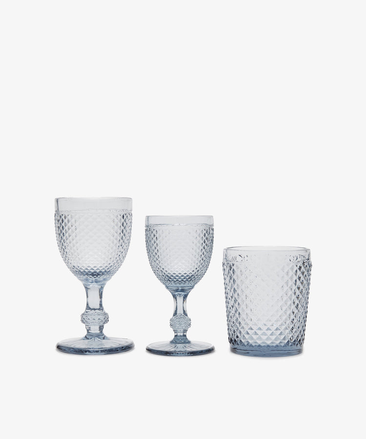 A set of six Celeste white wine glasses with diamond-cut textured surfaces, shown against a plain white background.