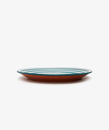 Natalia Platter. Green and white spiral striped glazed terracotta plate, angled side view.