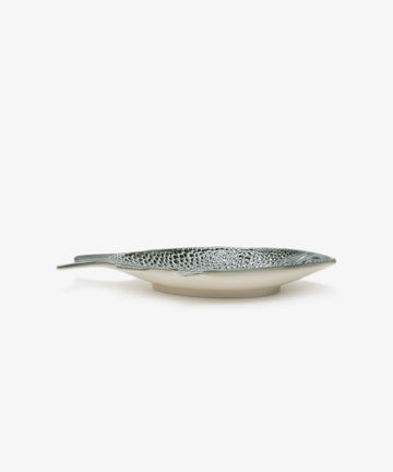 Peixe Platter. Glazed earthenware fish-shaped plate in green, side view.